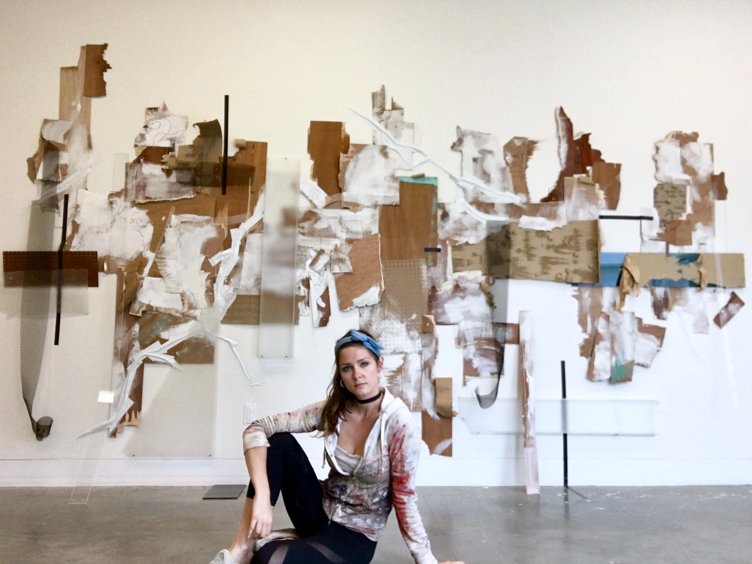 Artist Evelyn Sorochan-Ruland sitting in front of her art